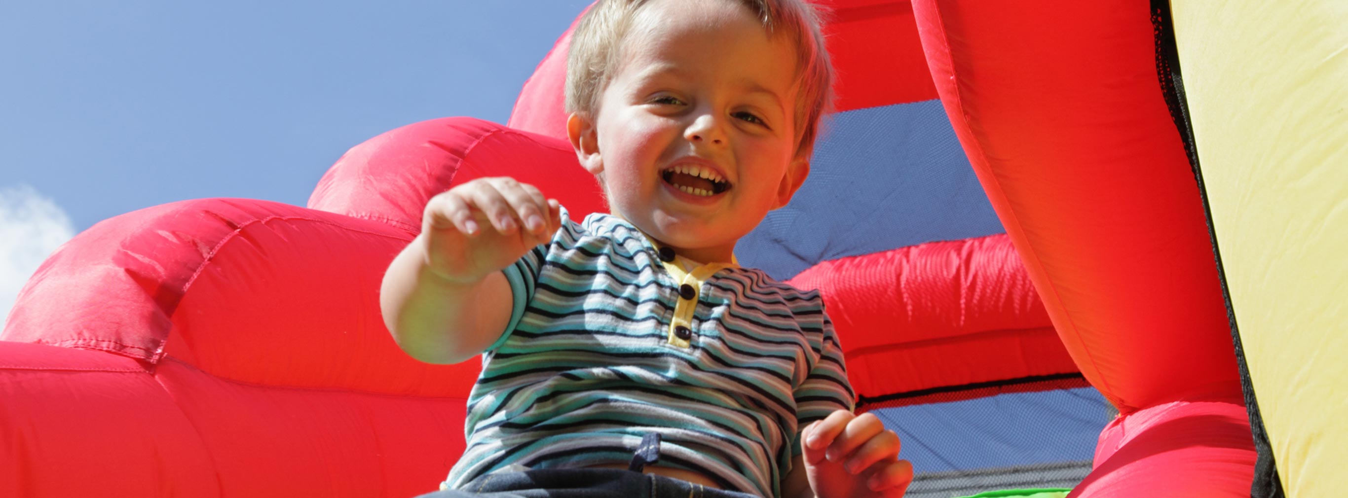 carnival amusements of s a a boy on an inflatable bouncy slide
