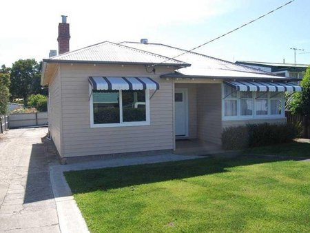 a home with a window on the front wall