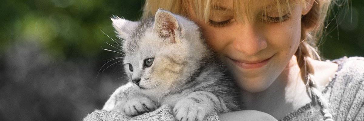 a girl holding a cat