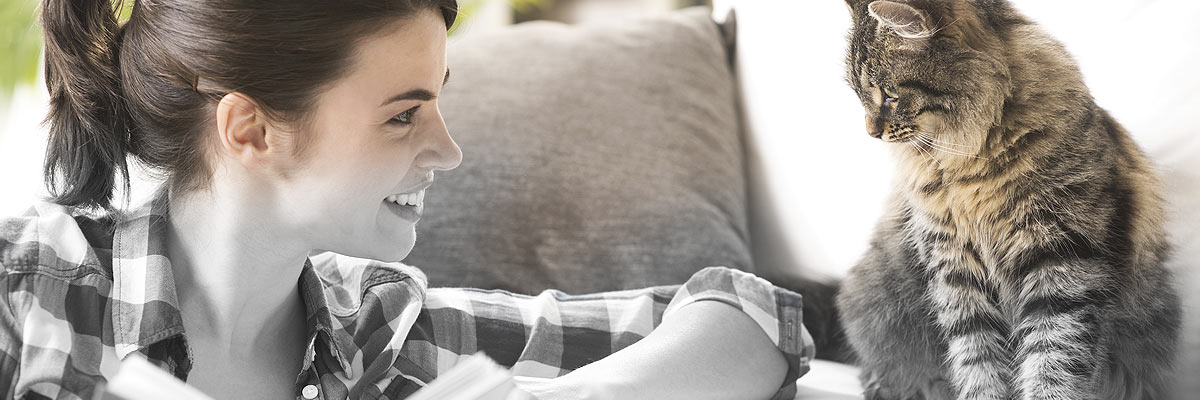 woman smiling at cat