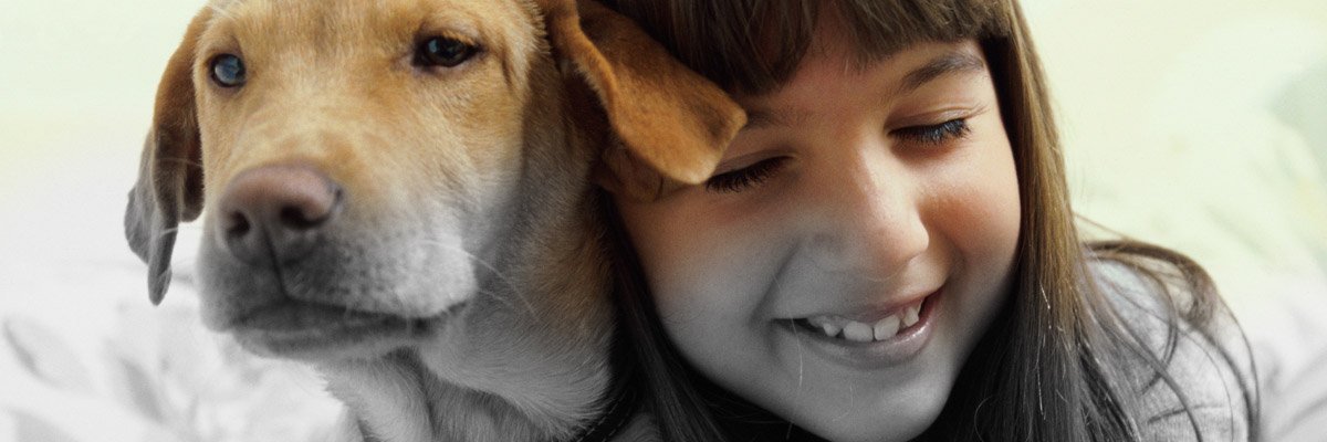 young girl hugging dog