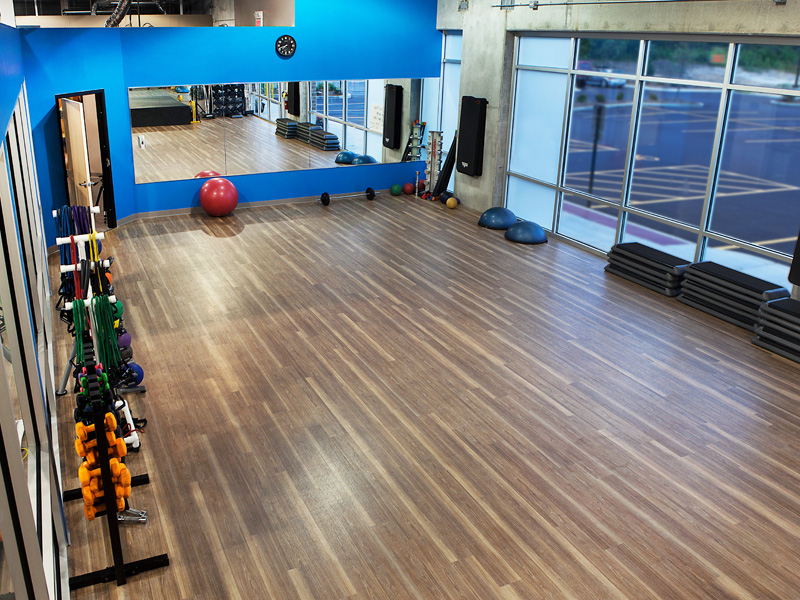 An aerial view of a gym with a large mirror on the wall