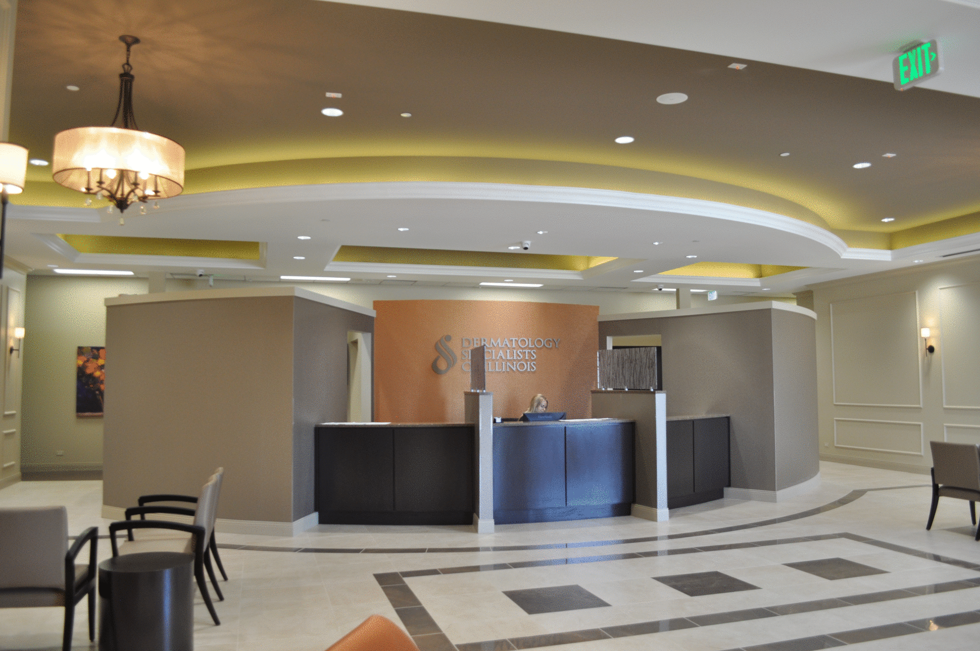 A large lobby with a reception desk and chairs.