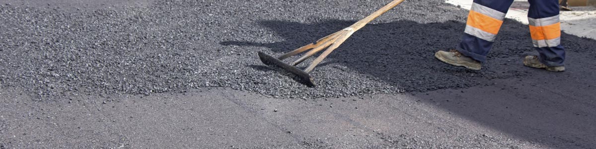 active asphalt man work on the road construction
