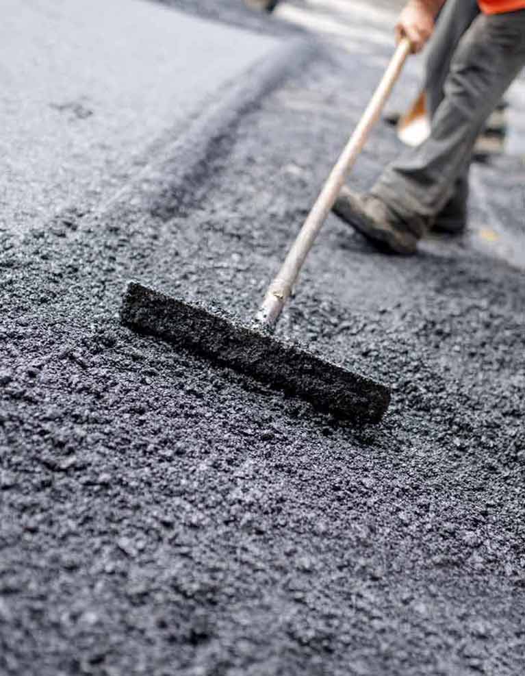 active asphalt worker work on the road construction
