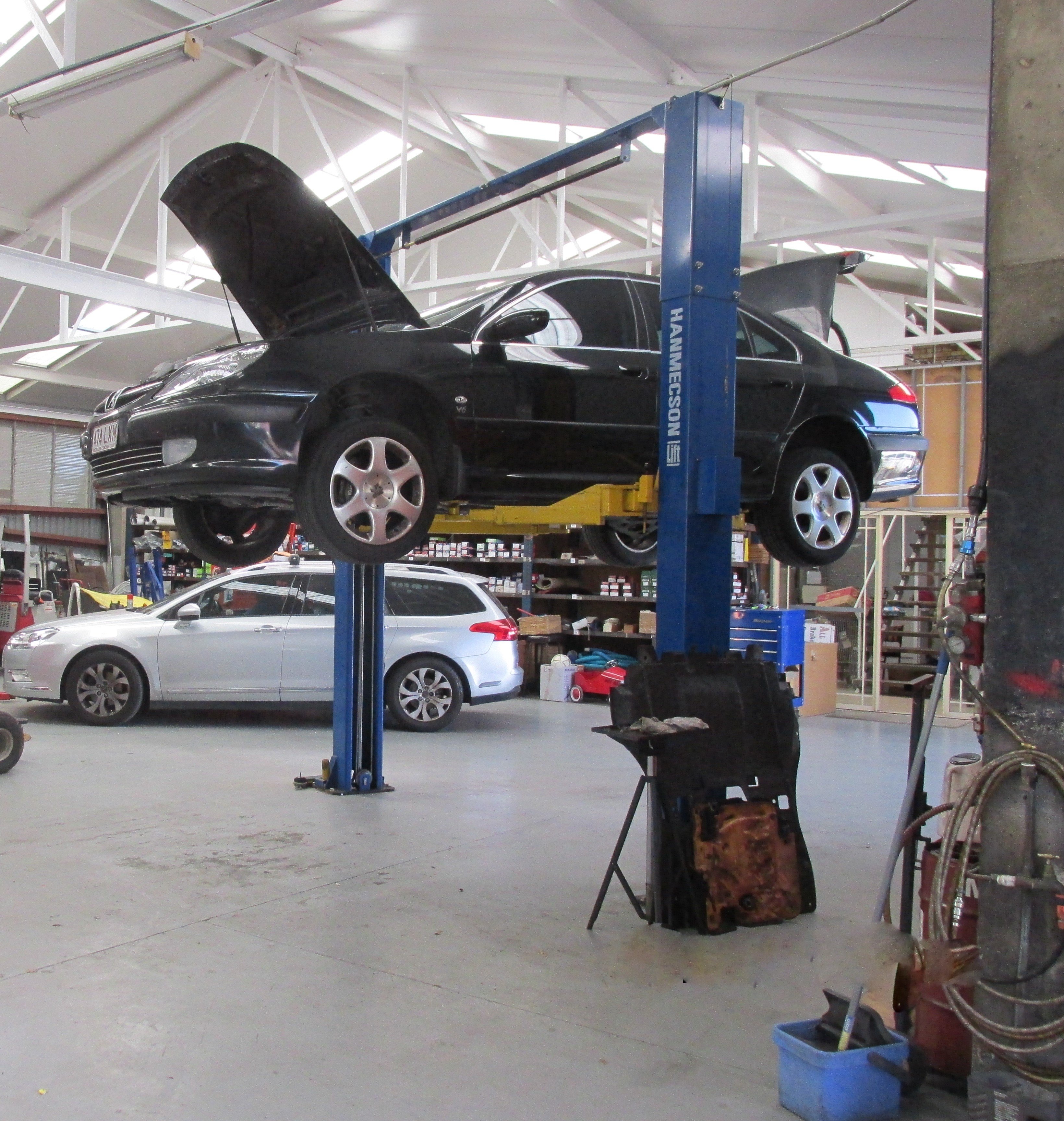 Full vehicle servicing being completed on a black car in Brisbane