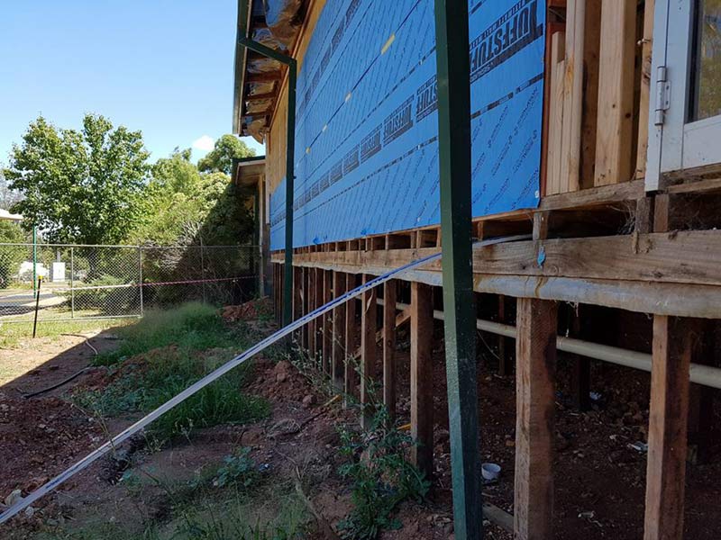 side of commercial building being raised