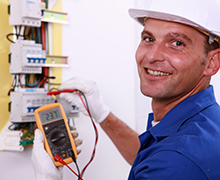 Electrician testing fusebox