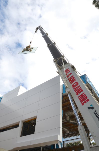 large crane next to modern building