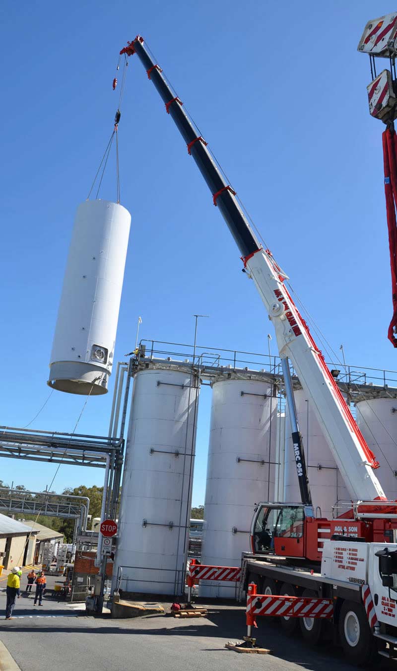 installing white cylinder with a crane