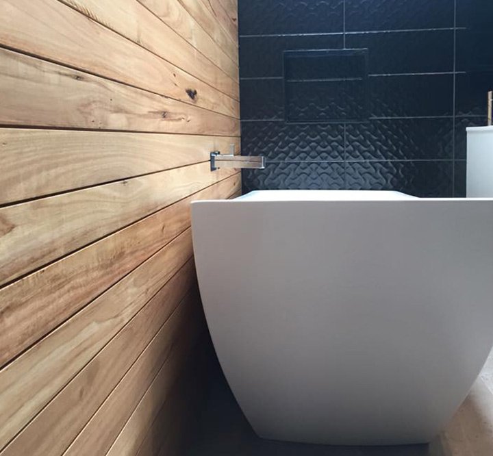 bathtub  with wooden wall