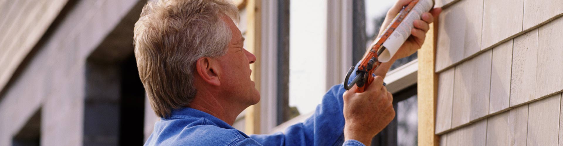 man finishing off window installation