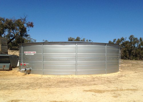 silver fire hydrant tank and blue sky