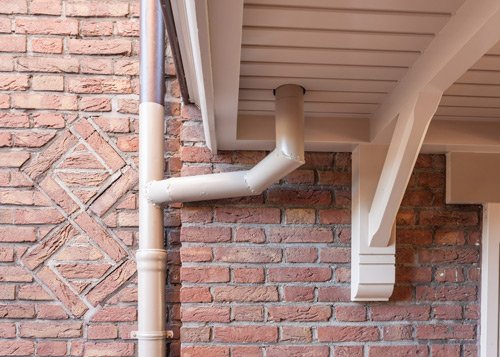 cream gutter on brick house