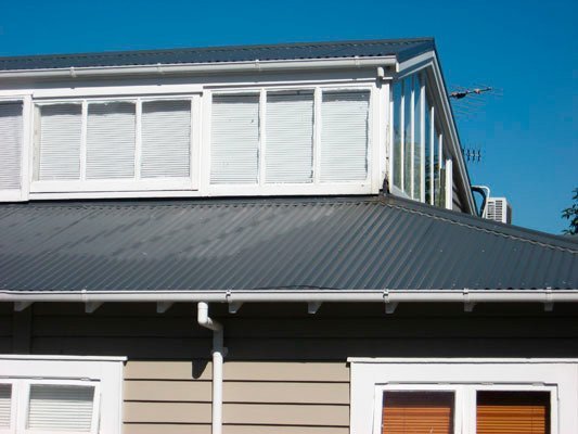 black metal roof and white trimmed windows