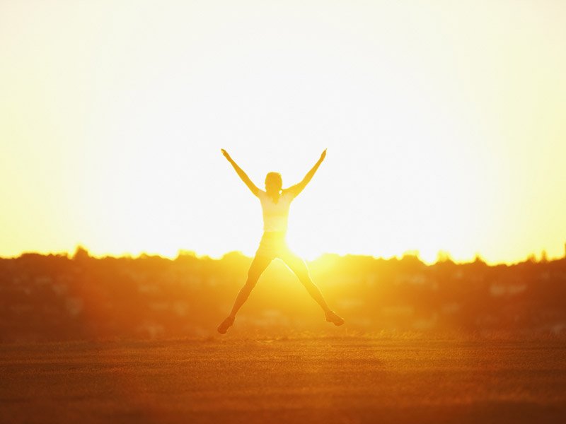 person jumping in sunset