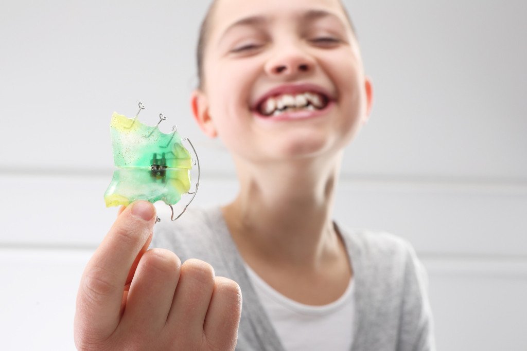 child with orthodontic device