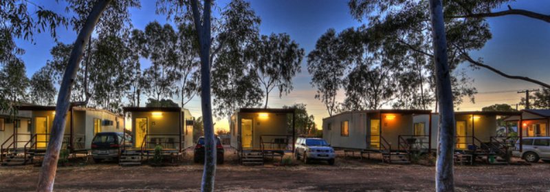 View of cars parked next to the houses at night