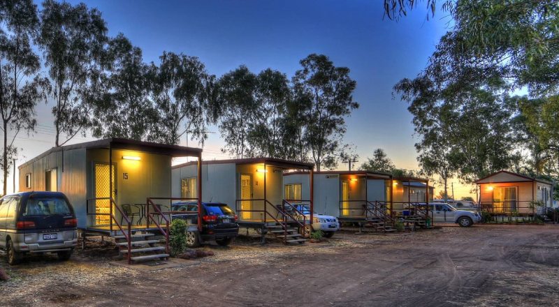 View of cars parked next to the houses at night