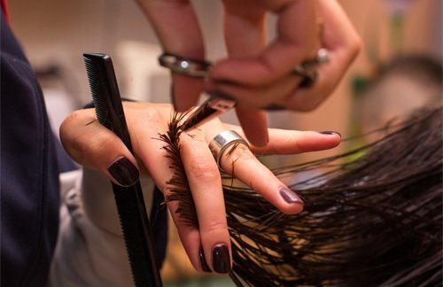 Customer getting a haircut in Cutting Edge which is a legacy of hair & style in Silverdale, NZ