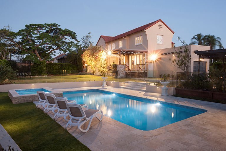 pool and house with lights on holland park