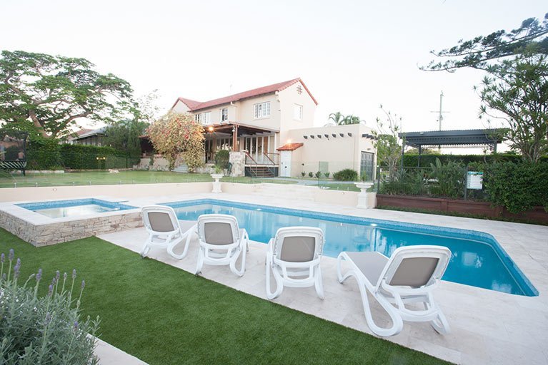 pool with deck chairs holland park