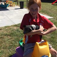young girl holding an animal