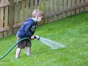 Buying_turf_in_warm_weather__0000_Boy watering