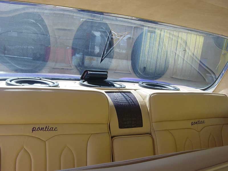 tan leather back seats and sub-woofers