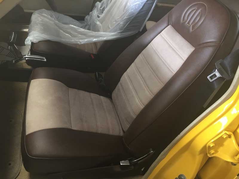interior front brown and tan leather seats in muscle car