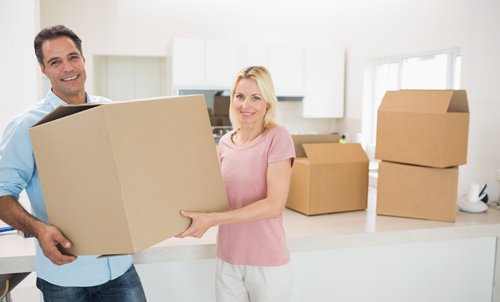 Couple with packed cartons ready for relocation