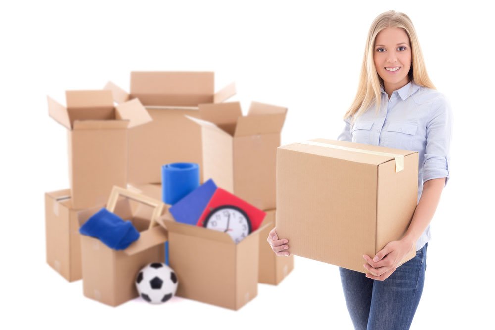 Woman with packed cartons ready for relocation
