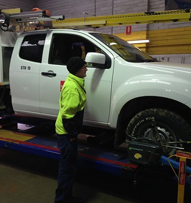 man standing next to vehicle