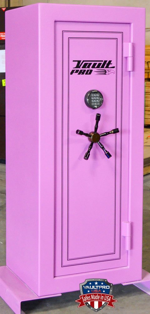 A pink safe is sitting on top of a concrete floor.