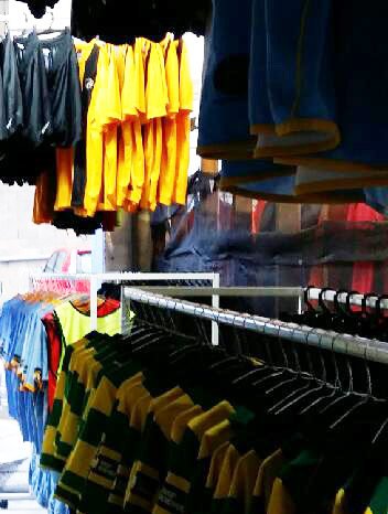 rows of clothing hanging with dark jacket at front