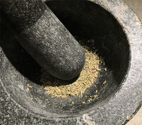 rosemary grinding in morter and pestil