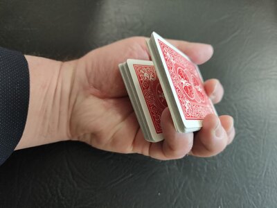 A playing card is seen to spin effortlessly on your finger tip.